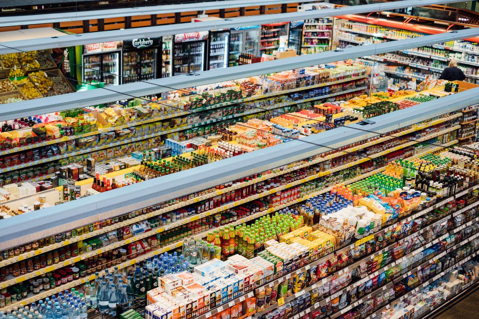 Explore the colorful, fully-stocked shelves of a bustling supermarket from above