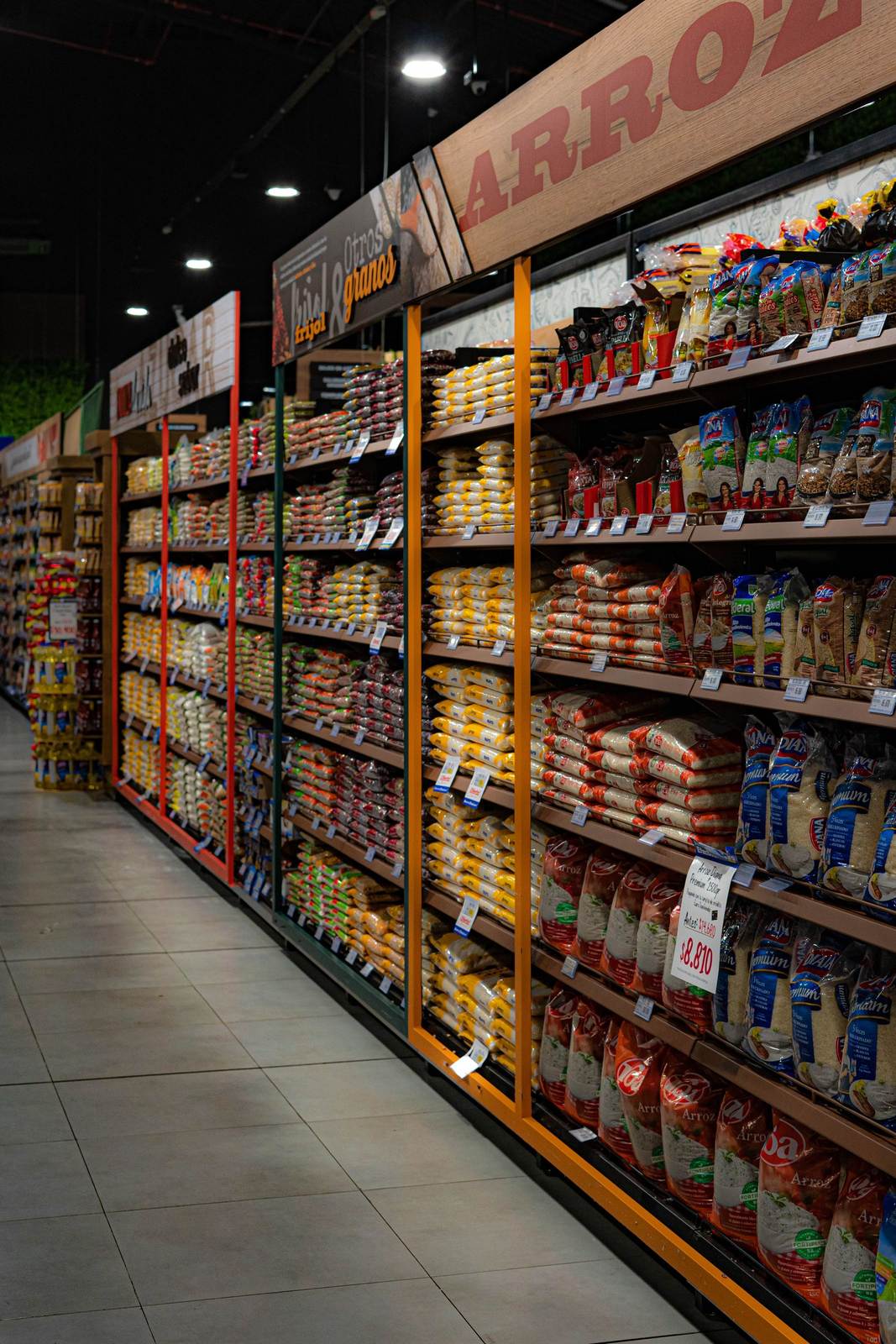 A grocery store aisle filled with various rice and grain packages neatly organized on shelves